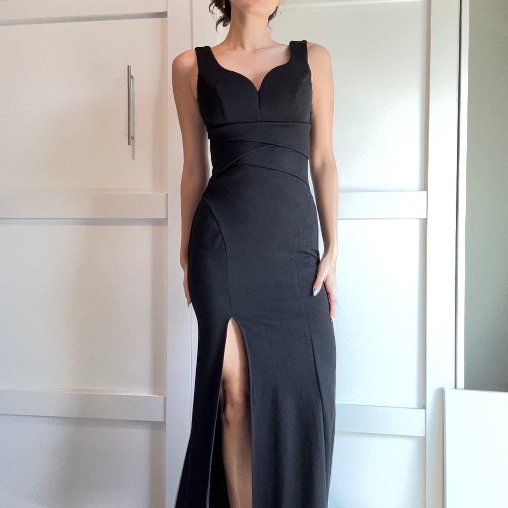 A black formal dress designed to highlight and flatter the feminine silhouette.